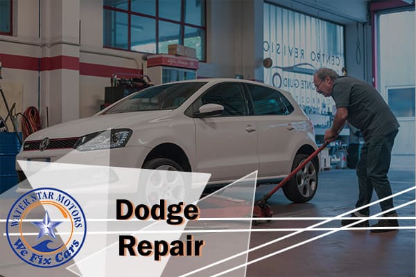 A mechanic performing repair and maintenance on a white Dodge car